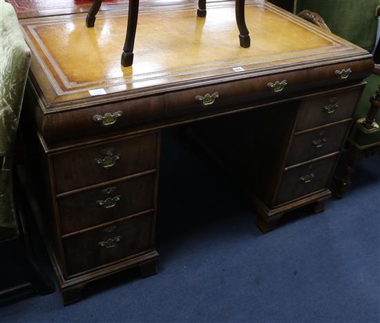 A 1920s yew veneered pedestal desk W.119cm